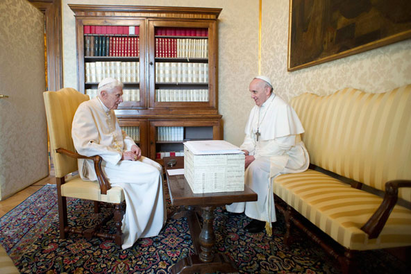 Emeritus Pope Benedict XVI talks with Pope Francis at the papal summer residence in Castel Gandolfo, Italy, March 23. Pope Francis travelled by helicopter from the Vatican to Castel Gandolfo for a private meeting with the retired pontiff. (CNS photo/L'Os servatore Romano via Reuters)