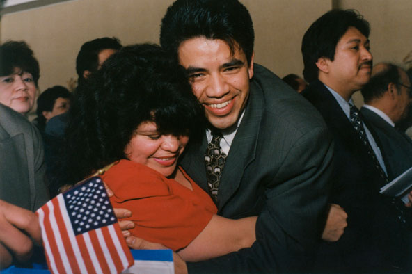Two Guatemalan immigrants embrace after becoming U.S. citizens in 1996 during a naturalization ceremony held at a Catholic church in Hyattsville, Md. Catholic Legal Immigration Network Inc., known as CLINIC, was created 25 years ago to support Catholic a gencies helping millions of people legalize their status following the 1986 passage of the Immigration Reform and Control Act. (CNS photo/Michael Alexander)