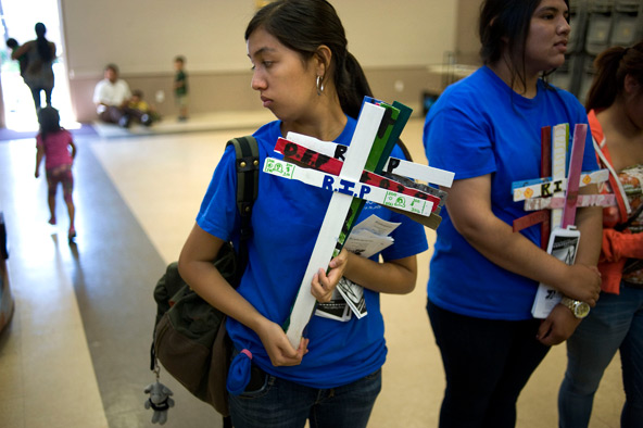 Activists with the immigration rights group Border Angels carry wooden crosses to a U.S. bishops' news conference on immigration reform legislation June 10 at Our Lady of Guadalupe Church in San Diego. The wooden crosses represent undocumented workers w ho have died crossing into the United States. (CNS photo/David Maung)