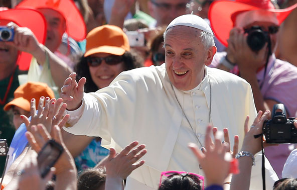 Pope Francis greets the crowd as he arrives to lead his general audience in St. Peter's Square at the Vatican June 19. (CNS photo/Paul Haring)