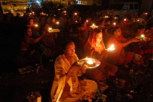 People in Ahmedabad, India, hold oil lamps as they pray for the flood victims in India's Uttarakhand state June 19. Church charity groups in India joined security personnel in rescue and relief work for hundreds of thousands of people affected by flash f loods and massive landslides in the country's northeast. (CNS photo/Amit Dave, Reuters) 