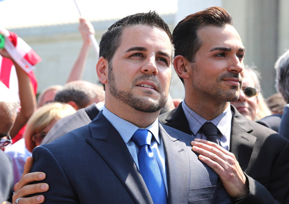 Jeff Zarrillo and Paul Katami, plaintiffs in the case against California's same-sex marriage ban known as Proposition 8, stand together in front of reporters as they depart the Supreme Court in Washington June 26. That morning the court ruled as unconsti tutional the federal Defense of Marriage Act, or DOMA, in a 5-4 decision. In a separate case the same day, the court sent back to lower courts a challenge to California's Proposition 8, the voter-approved initiative barring same-sex marriage.(CNS photo/J onathan Ernst, Reuters)