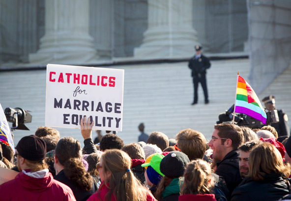 People demonstrate outside the Supreme Court building in Washington in this photo from late March, when the court heard oral arguments in two same-sex marriage cases. The court ruled as unconstitutional the federal Defense of Marriage Act, or DOMA, in a 5-4 decision issued June 26. In a separate case, the court sent back to lower courts a challenge to California's Proposition 8, the voter-approved initiative barring same-sex marriage. (CNS photo/Nancy Phelan Wiechec)