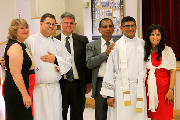 Fr. Chris Axline and Fr. Jurt Perera pose with their parents after their June 1 ordination to the priesthood at Ss. Simon and Jude Cathedral. (Ambria Hammel/CATHOLIC SUN)