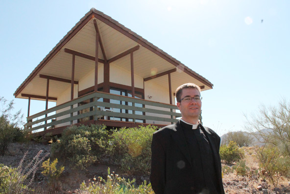 Fr. Eugene Florea stands by a resting quarters at Merciful Heart Hermitage, a house of prayer for priests in the Diocese of Phoenix. (J.D. Long-García/CATHOLIC SUN)