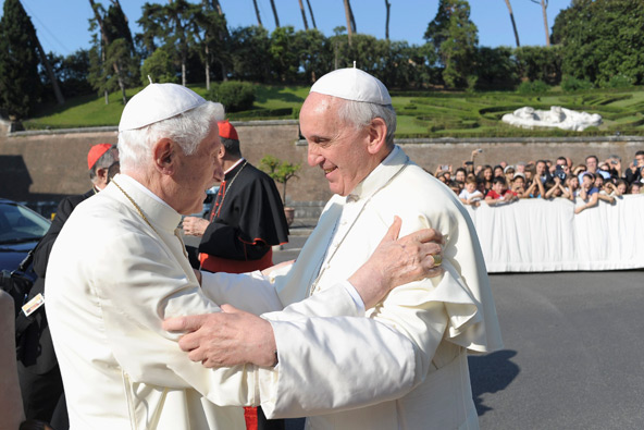 Pope Francis, right, embraces retired Pope Benedict XVI during a ceremony in the Vatican gardens July 5. During the service, Pope Francis blessed a new statue of St. Michael the Archangel and recited separate prayers to consecrate Vatican City to St. Joseph and to St. Michael. (CNS photo/L'Osservatore Romano via Reuters)