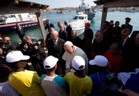 Pope Francis talks with immigrants at the port in Lampedusa, Italy, July 8. The pope called for repentance over treatment of migrants as he visited the Italian island where massive numbers of Africans have landed in attempts to reach Europe. (CNS photo/p ool via Reuters)