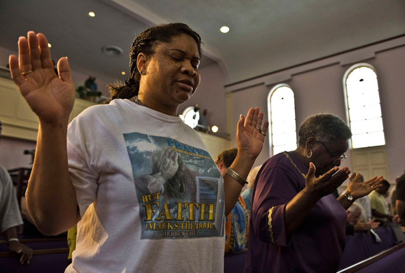 Women pray during a July 15 service at the New Life Word Center Church in Sanford, Fla., led by a coalition of local ministers in an effort to move the community past the George Zimmerman murder trial and verdict. After Zimmerman's July 13 acquittal in t he Trayvon Martin murder trial in Sanford, attention has now turned to how churches and communities can help heal the societal wounds of racism. (CNS photo/Steve Nesius, Reuters)
