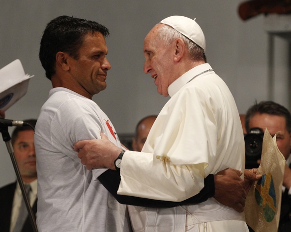 Pope Francis greets a man as he meets with patients, family and staff at St. Francis of Assisi Hospital in Rio de Janeiro July 24. The pope addressed a group of recovering drug addicts offering them a message of compassion and hope as well as a call to self-determination. (CNS photo/Paul Haring)