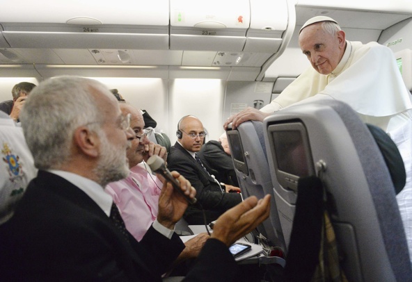 Pope Francis listens to a question from a journalist on his flight heading back to Rome July 29. The pope answered questions from 21 journalists over a period of 80 minutes on his return from Brazil. (CNS photo/pool via Reuters)
