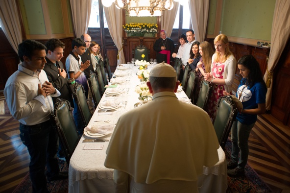 Twelve World Youth Day pilgrims stand with Pope Francis for grace before lunch at the archbishop's residence in Rio de Janeiro July 26. The pope showed the world on his first international trip that his forte as a communicator is the simple, seemingly artless action that resonates powerfully in context. (CNS photo/L'Osservatore Romano)