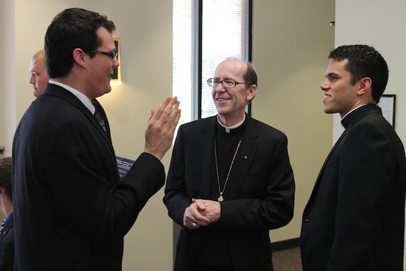 Bishop Thomas J. Olmsted catches up with seminarians _____ and Fernando Camou at the Diocesan Pastoral Center July 23. (Ambria Hammel/CATHOLIC SUN)