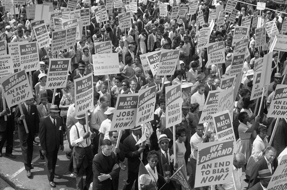 Demonstrators holding signs march during the 1963 March on Washington. As the 50th anniversaries of key civil rights events approach, some observe that there's still a long way to go toward eliminating racism in U.S. society. (CNS photo/Library of Congress) 
