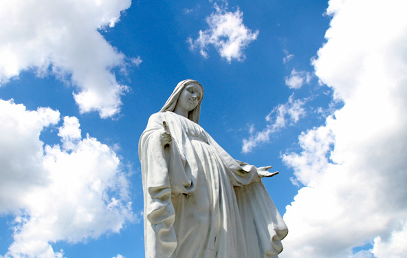 A statue of Mary overlooks the grounds of St. Jude Church in Mastic Beach, N.Y., Aug. 4. The feast of the Assumption of the Blessed Virgin Mary, Aug. 15, celebrates the belief that Mary was taken body and soul into heaven at the end of her life. (CNS pho to/Gregory A. Shemitz) 