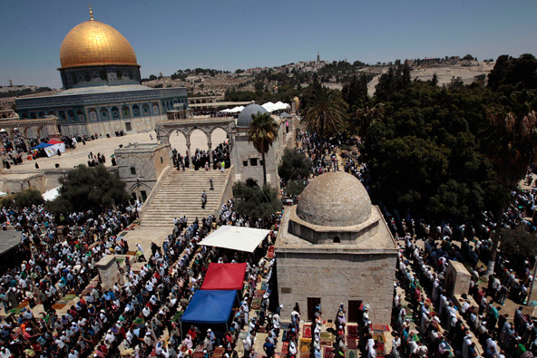 The Dome of the Rock is seen in the background as Palestinians attend Friday prayers on the compound known to Muslims as al-Harem al-Sharif and to Jews as Temple Mount in Jerusalem's Old City, during the Muslim holy month of Ramadan Aug. 2. On Aug. 14, Palestinians and Israelis were to hold their first formal peace talks in the Mideast in nearly five years. (CNS photo/Ammar Awad, Reuters) 