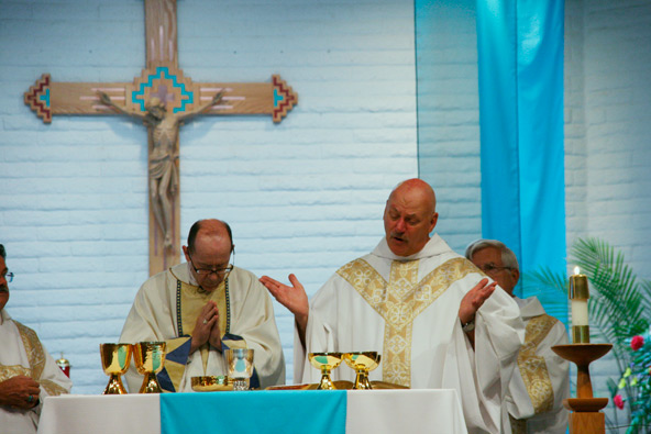 Holy Cross Father Ed Kaminski prays alongside Bishop Thomas J. Olmsted during the July 27 Mass marking the 40th anniversary of Our Lady of the Valley. (Kevin Theriault/CATHOLIC SUN)