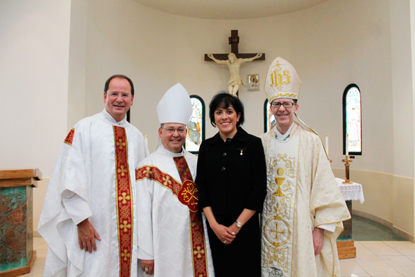 Fr. Fred Adamson, vicar general, Auxiliary Bishop Eduardo A. Nevares, Dr. Maria Romo Chavira and Bishop Thomas J. Olmsted pose for a photo in the Diocesan Pastoral Center Chapel after the Aug. 20 installation of Chavira as chancellor of the Diocese of Phoenix. 