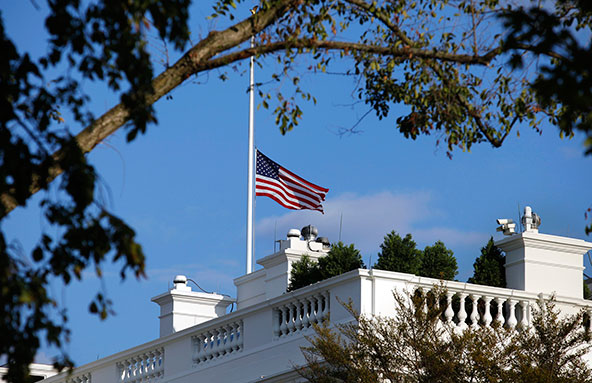 A U.S. flag flies at half staff at the White House Sept. 16 in remembrance of victims of a shooting at the Washington Navy Yard that day. At least 13 people were killed, including gunman Aaron Alexis, and eight others wounded when Alexis opened fire at t he Naval Sea Systems Command headquarters, authorities said. (CNS photo/Yuri Gripas, Reuters)