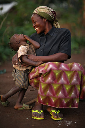 Sister Angelique Namaika, a member of the Augustine Sisters of Dungu and Doruma, embraces a Congolese child at a site for internally displaced people Aug. 1 in Congo. Sister Angelique received the 2013 Nansen Refugee Award from the U.N. High Commissioner for Refugees Sept. 17 for her work with women forced to leave their homes in northeastern Congo because of long-term civil strife. (CNS photo/Brian Sokol, courtesy UNHR) 