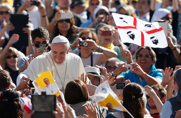 A man waves Sardinia's flag as Pope Francis greets people during his general audience in St. Peter's Square at the Vatican Sept. 18. The pope will visit Cagliari on the Italian island of Sardinia Sept. 22. (CNS photo/Paul Haring)