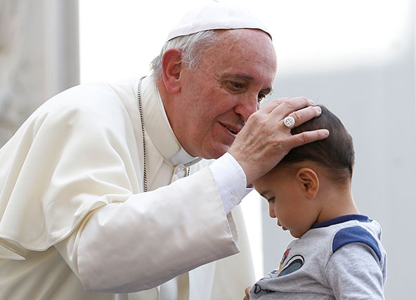 Pope Francis blesses a boy as he leaves his general audience in St. Peter's Square at the Vatican Sept. 25. (CNS photo/Paul Haring)