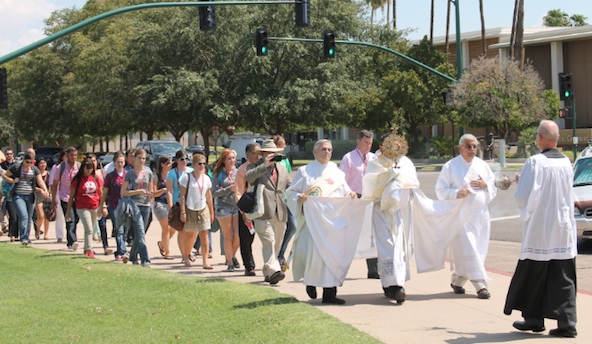 Fr. Dan Vayno, chaplain of Benedictine University at Mesa, leads a one-mile eucharistic procession from campus to Queen of Peace Parish Sept. 4 where he celebrated the college's first Mass. (Ambria Hammel/CATHOLIC SUN).