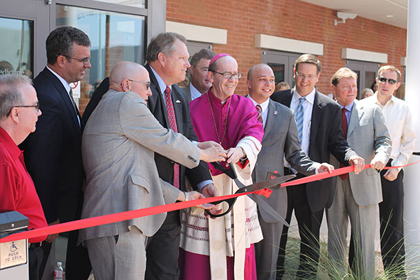 Dr. William Carroll, president of Benedictine University, Mesa Mayor Scott Smith and Bishop Thomas J. Olmsted join other campus and city leaders for a ceremonial ribbon cutting Aug. 27 marking the arrival of a full four-year Catholic campus. (J.D. Long-García/CATHOLIC SUN)