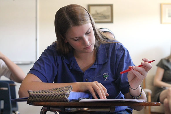 A senior at Xavier College Preparatory proofs a classmate's college admission essay during English class. The U.S. Department of Education honored Xavier as a Blue Ribbon School in the "Exemplary High Performing" category. (Ambria Hammel/CATHOLIC SUN)