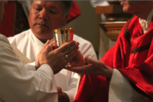 Purifying the vessels is one service eight deacon candidates can now provide after Bishop Thomas J. Olmsted instituted eight men to the ministry of the altar.  (Ambria Hammel/CATHOLIC SUN)