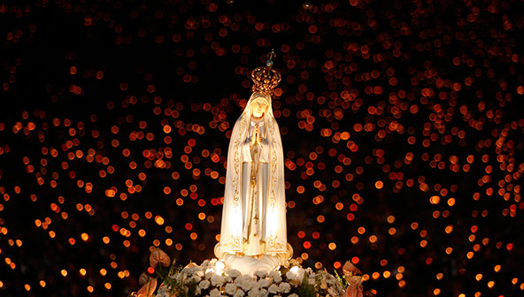 A statue of Our Lady of Fatima is carried during a candlelight vigil at the shrine in Fatima, Portugal, Oct. 12, 2007. An estimated 300,000 pilgrims converged in Fatima to celebrate the 90th anniversary of the first apparition of Mary to three shepherd children in 1917. A new, modern church was also dedicated at the shrine. (CNS photo/Nacho Doce, Reuters)