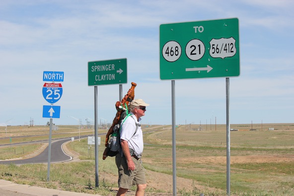 John Moore of Gallup, N.M., carries a wooden cross along a New Mexico highway in memory of Korean War hero Father Emil Kapaun in this 2011 file photo. Moore made a 630-mile pilgrimage from Santa Fe, N.M., to Pilsen, Kan., arriving at Father Kapaun's home parish by Veteran's Day. (CNS photo/Joseph Kolb)