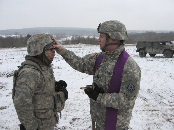 Army chaplain Father Christopher Butera administers ashes to soldiers training in the field on Ash Wednesday earlier this year. Father Butera, who was deployed to Afghanistan in mid-August, is a priest of the Diocese of Allentown, Pa. (CNS photo/courtesy of Father Butera)