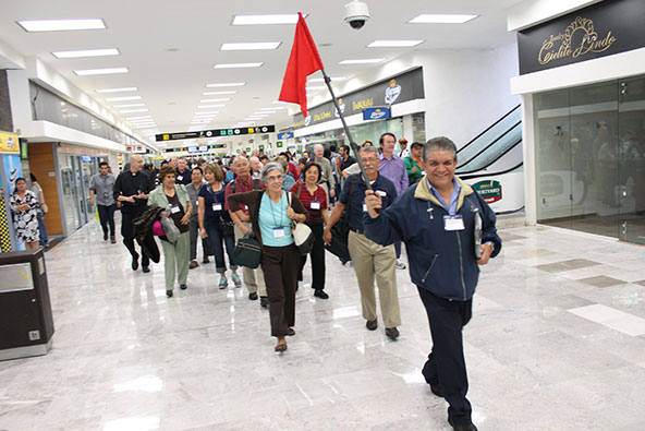José Alfredo Martinez leads pilgrims through the Mexico City Airport. 