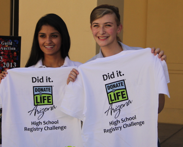 Meghan Grewal and Annaise White show off T-Shirts among other thank you tokens they gave fellow Xavier students who signed up to be an organ and tissue donor Oct. 22 (Ambria Hammel/CATHOLIC SUN)