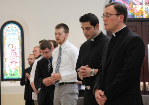 Kevin Grimditch, right, prays with fellow seminarians and staff at the Diocesan Pastoral Center July 23 (Ambria Hammel/CATHOLIC SUN)