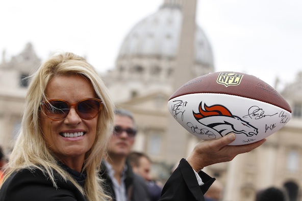 Linda Del Rio holds a football signed by members of the Denver Broncos, outside St. Peter's Square at the Vatican Oct. 20. Del Rio was in town to attend a Vatican sports meeting and present the football to Pope Francis. (CNS photo/Paul Haring) 