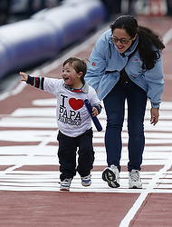 An Italian woman and her son run in a 100-meter relay race on the main road leading to St. Peter's Square at the Vatican Oct. 20. The Year of Faith event drew several hundred people, including Olympians, Paralympians, families and children. (CNS photo/Paul Haring)