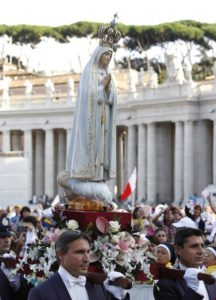 The original statue of Our Lady of Fatima arrives in procession for a Marian vigil led by Pope Francis in St. Peter's Square at the Vatican Oct. 12. The statue was brought from Portugal for a weekend of Marian events culminating in Pope Francis en trusting the world to Mary. (CNS photo/Paul Haring)