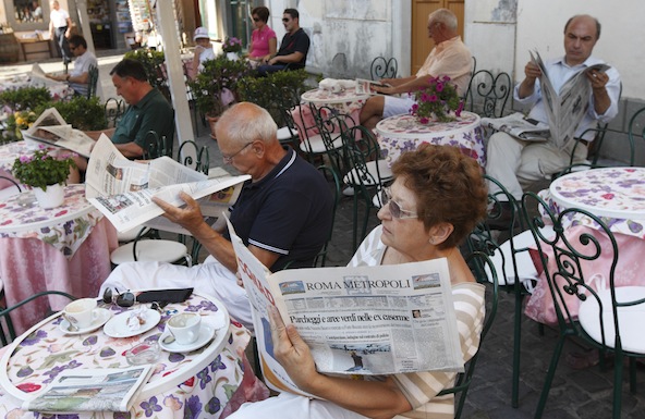 People read newspapers in the morning at a coffee shop outside the papal villa at Castel Gandolfo, Italy, in this 2010 file photo. (CNS photo/Paul Haring)