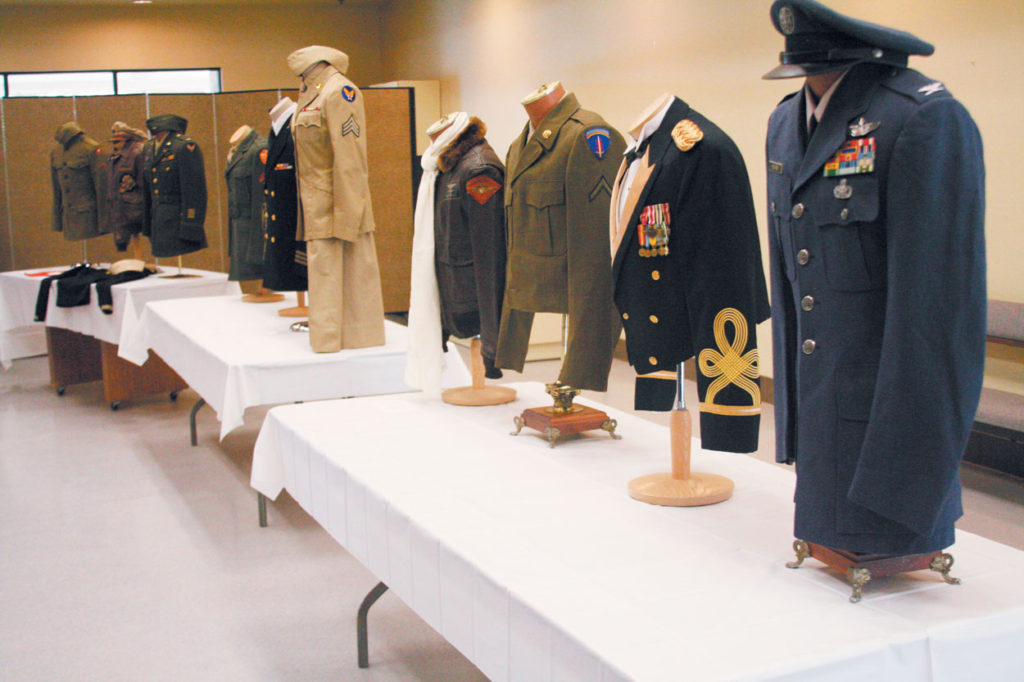 A display of uniforms worn by various members of the American military greeted guests who attended a reception following the first Red, White and Blue Mass in 2011. (Ambria Hammel/CATHOLIC SUN FILE PHOTO)