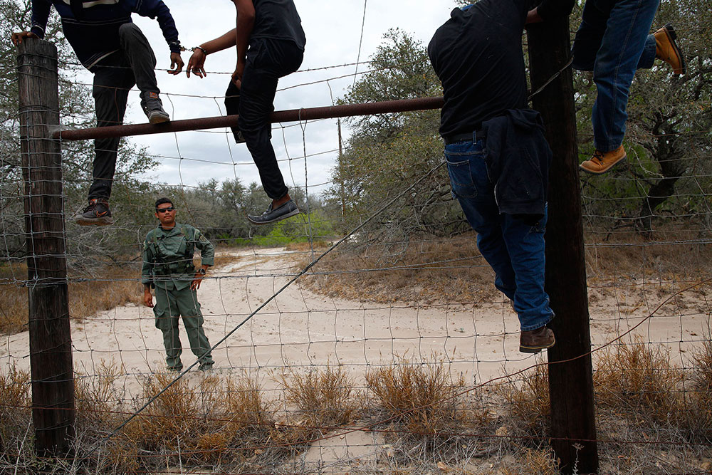 People are taken into custody by the U.S. Border Patrol near Falfurrias, Texas, in this March 29 file photo. (CNS photo/Eric Thayer, Reuters)