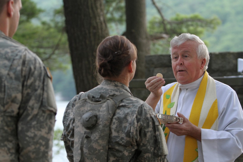 Augustinian Father Edson Wood, brigade chaplain at the U.S. Military Academy, distributes Communion during Mass at Camp Buckner in West Point, N.Y., in 2011. A special national collection taking place at weekend Masses Nov. 9 and 10 will help the U.S. Ar chdiocese for the Military Services and its chaplains "serve those who serve" their country, says Archbishop Timothy P. Broglio, who heads the archdiocese. (CNS photo/Gregory A. Shemitz)