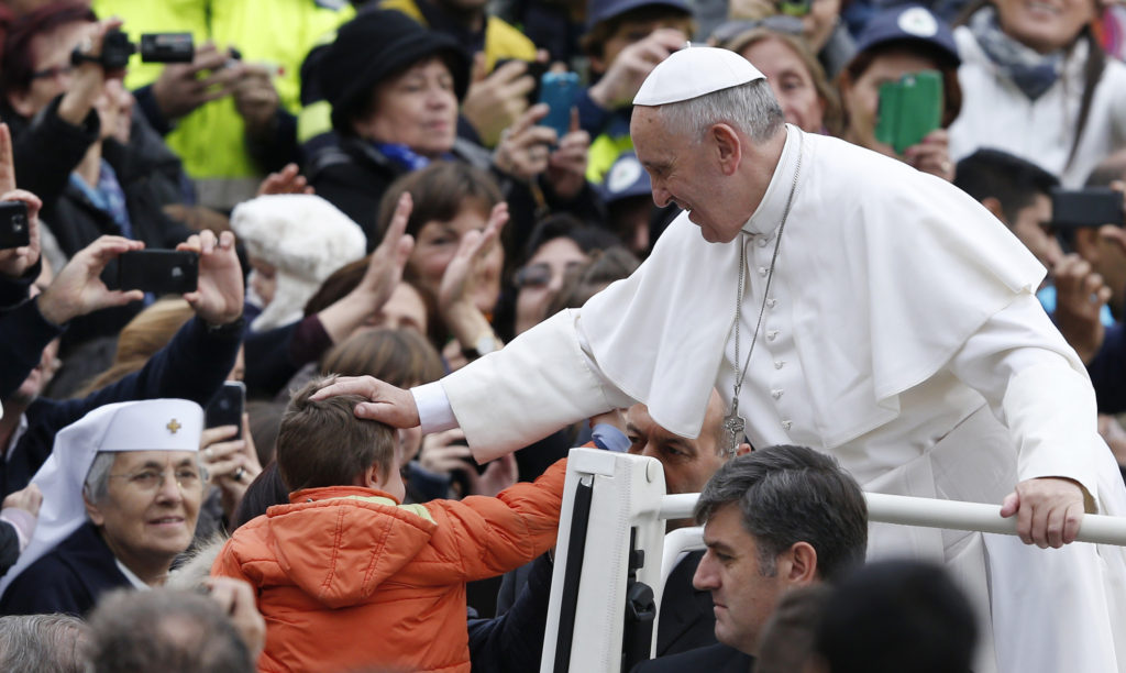 Pope Francis, shown here as he arrives to lead his general audience in St. Peter's Square at the Vatican Nov. 20, says in a new document on "The Joy of the Gospel," that an "evangelizer must never look like someone who has just come back from a funeral!" (CNS/Paul Haring)