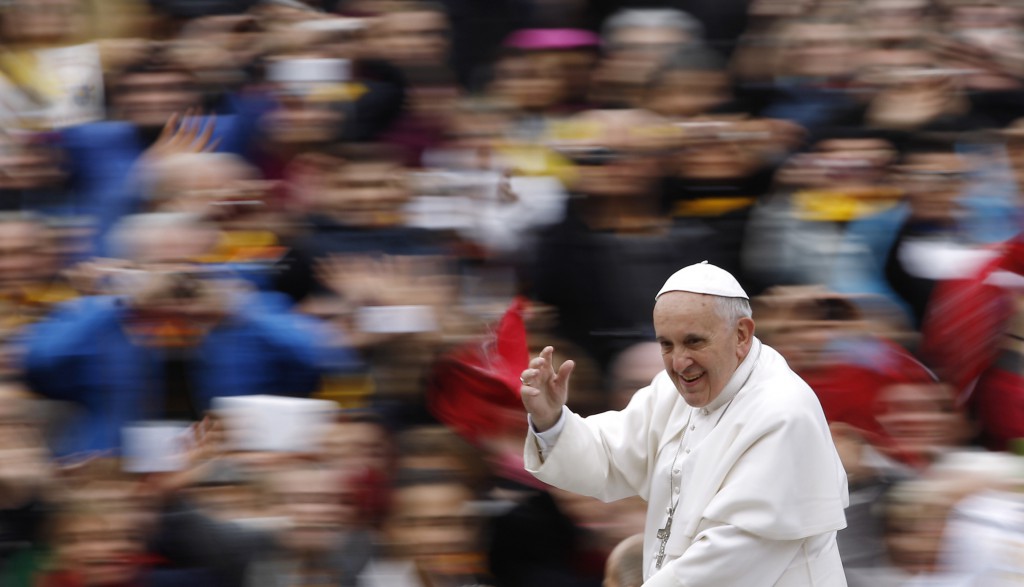 Pope Francis, shown here as he arrives to lead his general audience in St. Peter's Square at the Vatican Nov. 20, says in a new document on "The Joy of the Gospel," that an "evangelizer must never look like someone who has just come back from a funeral!" (CNS/Paul Haring)