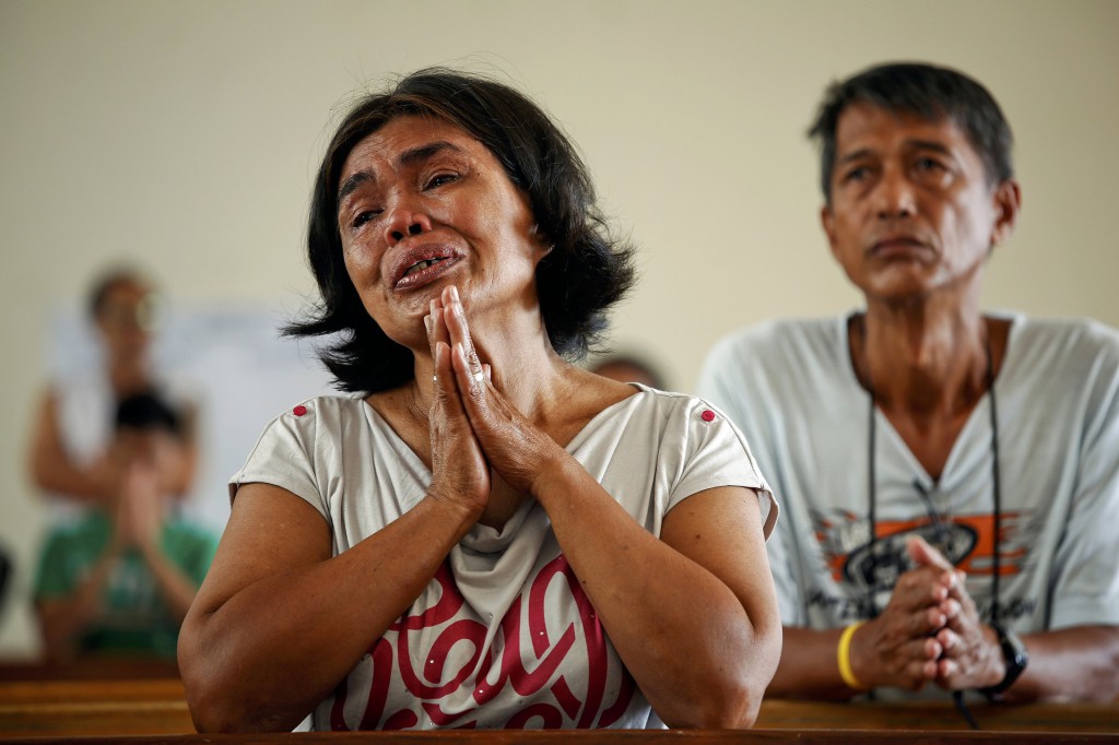 Rosario Capidos cries while thanking God that she and her family survived Typhoon Haiyan as she prays during Mass inside the damaged Minor Basilica of the Holy Child Nov. 17 in Tacloban, Philippines. Long-delayed emergency supplies flowed into the typhoon-ravaged central Philippines, reaching desperate families who had to fend for themselves for days, as the United Nations more than doubled its estimate of homeless to nearly 2 million. (CNS photo/Damir Sagolj, Reuters)