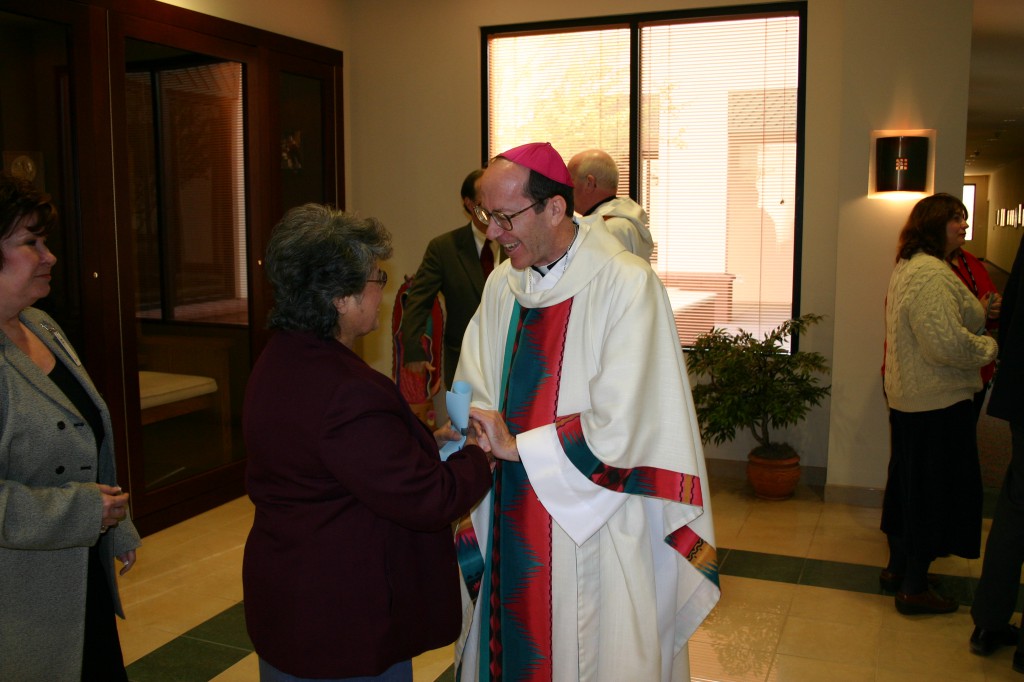 Sr. Maria Celia Molina, SNDdeN, greets Bishop Thomas J. Olmsted Nov. 25, 2003, the day his appointment to the Diocese of Phoenix was announced. (Robert DeFrancesco/CATHOLIC SUN)