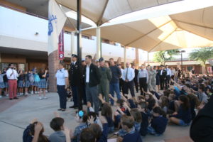 Blessed Pope John XXIII students extend their hands in blessing as some 35 active duty and retired military personnel process into the courtyard for a Veterans Day celebration.  (courtesy of Blessed Pope John XXIII School)