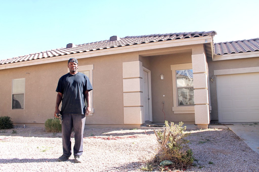 Terrance Alston poses in front of a vacant house in Chandler Nov. 1 that he is fixing up. He is one of 925 client success stories St. Joseph the Worker could tell from one year alone. The agency seeks a mobile unit to take its services to more homeless clients seeking employment and stability. (Ambria Hammel/CATHOLIC SUN)