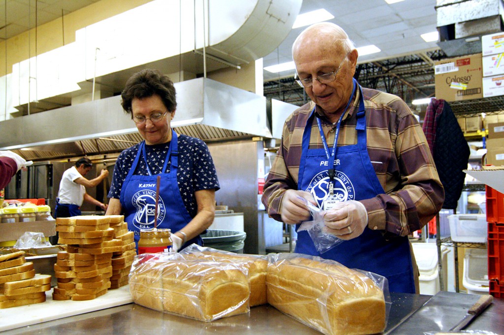 Thousands of people in need would go hungry were it not for the daily efforts of social service agencies across the Valley. Those efforts rely heavily on volunteers like Peter and Kathy Maland, pictured here in this 2008 photo, who have served faithfully at the Society of St. Vincent de Paul for nearly three decades. “I was brought up in poverty,” the Italian immigrant said. Maland went on to success in insurance sales and retired to life at St. Vincent de Paul. (File photo by Ambria Hammel, The Catholic Sun.)