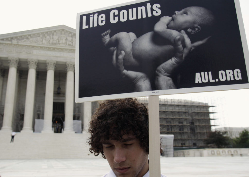 A pro-life activist holds a sign during a rally in front of U.S. Supreme Court in Washington June 25. (CNS photo/Yuri Gripas, Reuters)